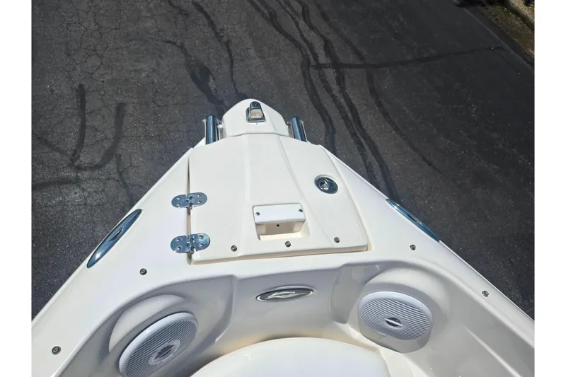 Slide: The Image of 2008 Rinker 226 Captiva Bowrider boat bow with speakers and hatch on pavement. - 19