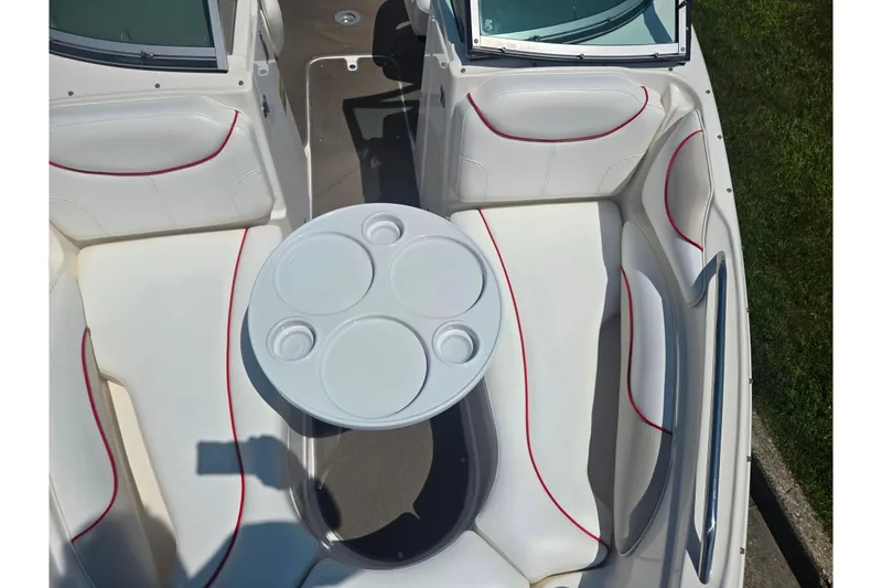 Slide: The Image of 2008 Rinker 226 Captiva Bowrider interior with white seating and round table. - 20