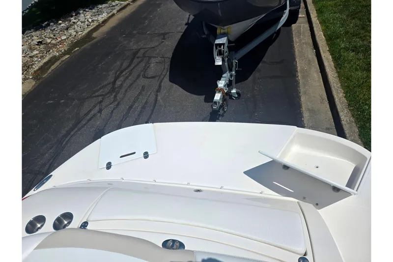 Slide: The Image of 2008 Rinker 226 Captiva Bowrider on trailer, parked on asphalt road. - 27