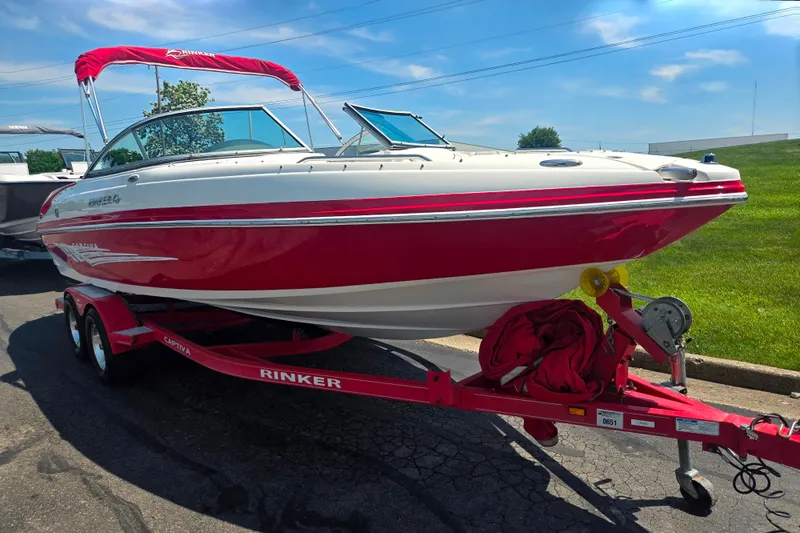 Slide: The Image of 2008 Rinker 226 Captiva Bowrider on trailer, red and white design, sunny day. - 5