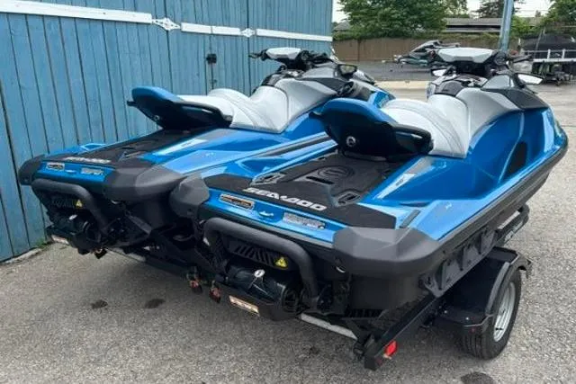 Slide: The Image of Two blue 2021 Seadoo GTI SE 130 jet skis on a trailer. - 1