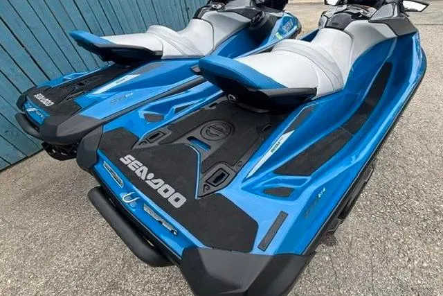 Slide: The Image of 2021 Seadoo GTI SE 130 jet skis in blue, parked on pavement. - 14