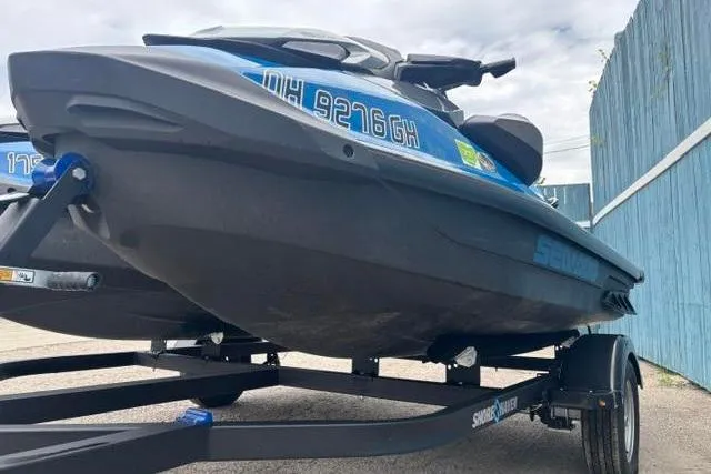 Slide: The Image of 2021 Seadoo GTI SE 130 jet ski on trailer, parked outdoors. - 4