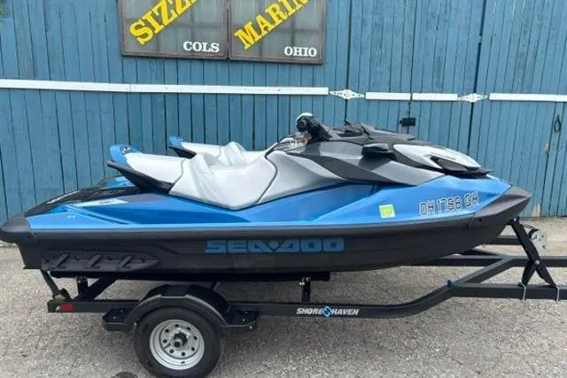 Slide: The Image of 2021 Seadoo GTI SE 130 jet ski on trailer, blue and black, parked at marina. - 9