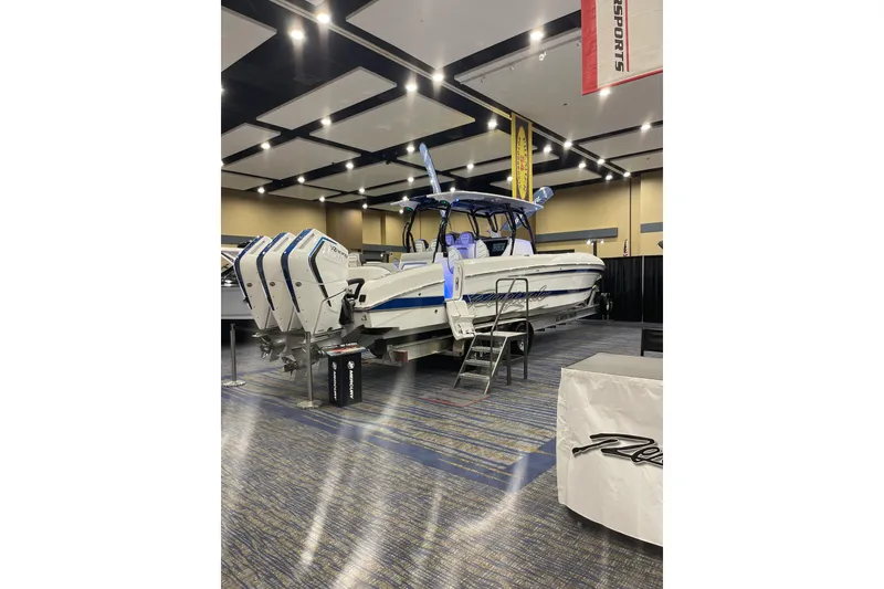 Slide: The Image of 2026 Renegade 38 Open boat displayed indoors with multiple outboard engines. - 1