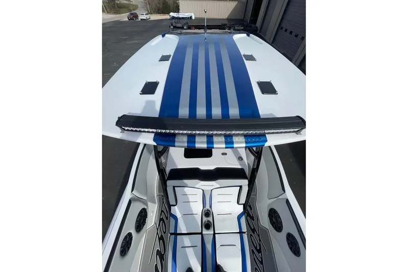 Slide: The Image of 2026 Renegade 38 Open boat with sleek blue stripes and modern design. - 11