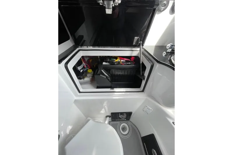 Slide: The Image of Interior storage compartment of 2026 Renegade 38 Open boat, featuring organized equipment. - 18