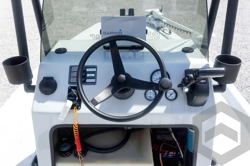Slide: The Image of Steering console of a 2017 Shoalwater 19' Catamaran with Garmin navigation system. - 18