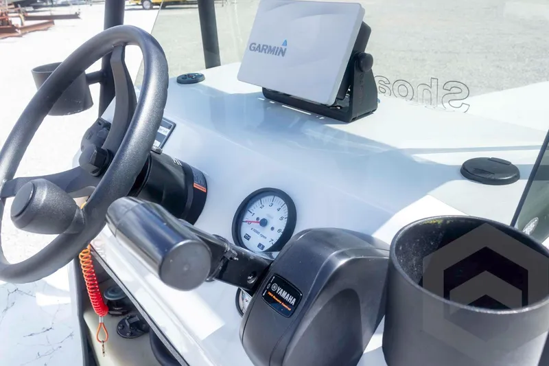 Slide: The Image of 2017 Shoalwater 19' Catamaran dashboard with Garmin GPS and Yamaha controls. - 19
