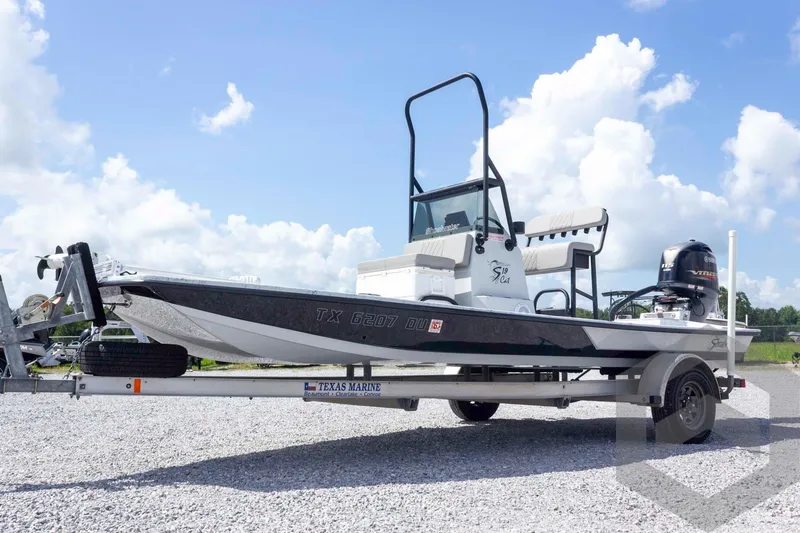 Slide: The Image of 2017 Shoalwater 19' Catamaran on trailer under a clear blue sky. - 2