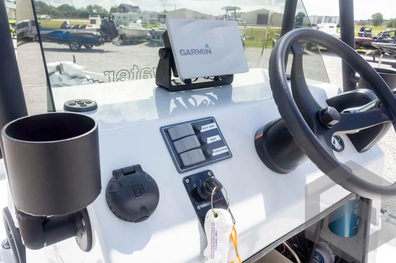 Slide: The Image of 2017 Shoalwater 19' Catamaran dashboard with Garmin GPS and steering wheel. - 20