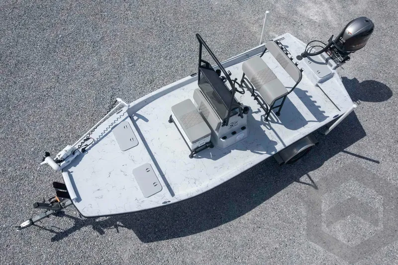 Slide: The Image of 2017 Shoalwater 19' Catamaran on gravel, featuring dual seats and outboard motor. - 25