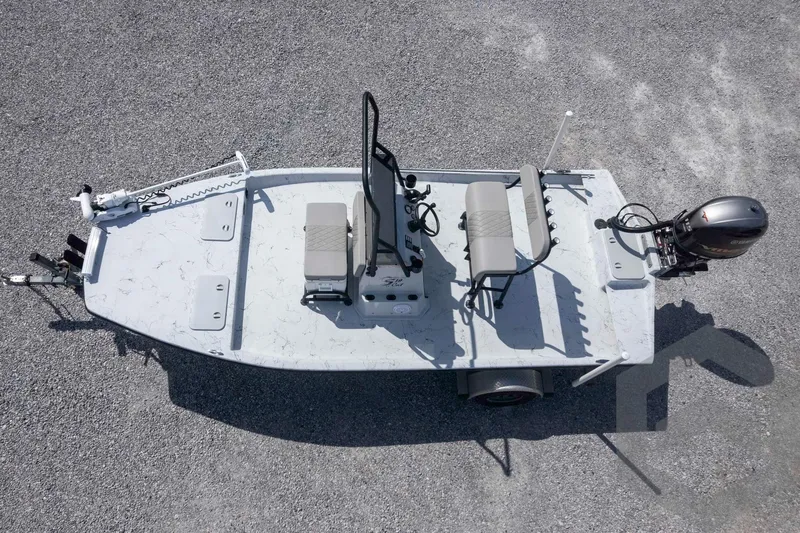 Slide: The Image of 2017 Shoalwater 19' Catamaran on gravel, aerial view, showcasing seating and motor. - 26