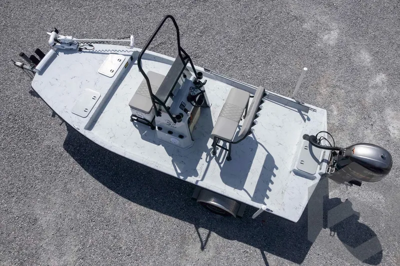 Slide: The Image of 2017 Shoalwater 19' Catamaran on gravel, featuring dual seats and outboard motor. - 27