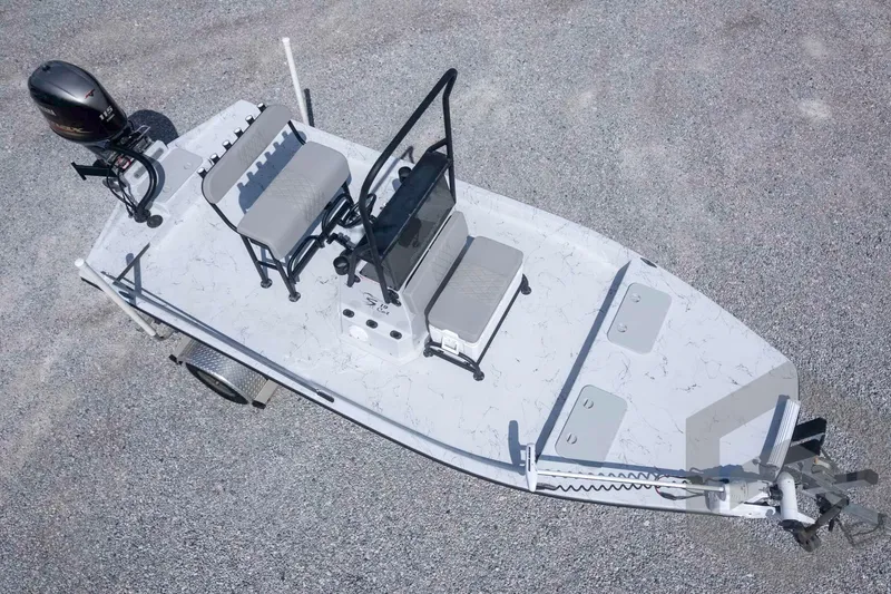 Slide: The Image of 2017 Shoalwater 19' Catamaran on gravel, featuring dual seats and outboard motor. - 31