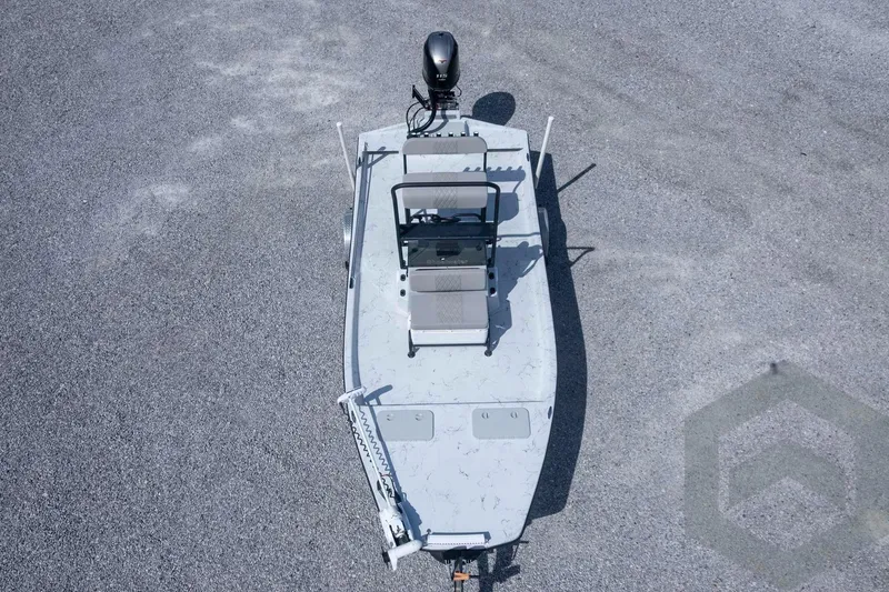 Slide: The Image of 2017 Shoalwater 19' Catamaran on gravel, aerial view, featuring motor and seating. - 32