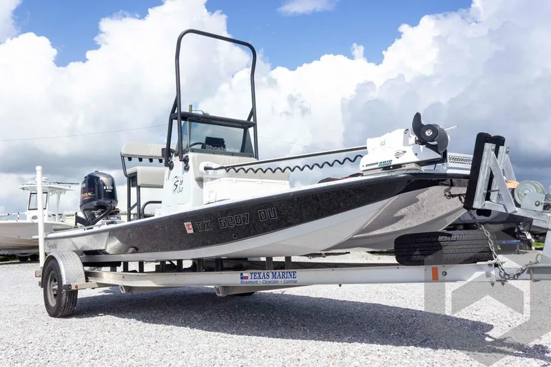 Slide: The Image of 2017 Shoalwater 19' Catamaran on trailer, featuring sleek design and powerful outboard motor. - 4