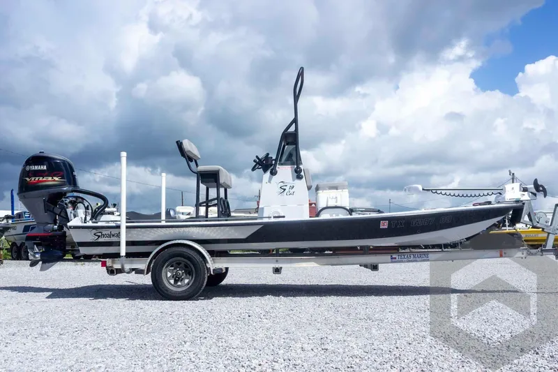 Slide: The Image of 2017 Shoalwater 19' Catamaran with Yamaha engine on trailer under cloudy sky. - 5