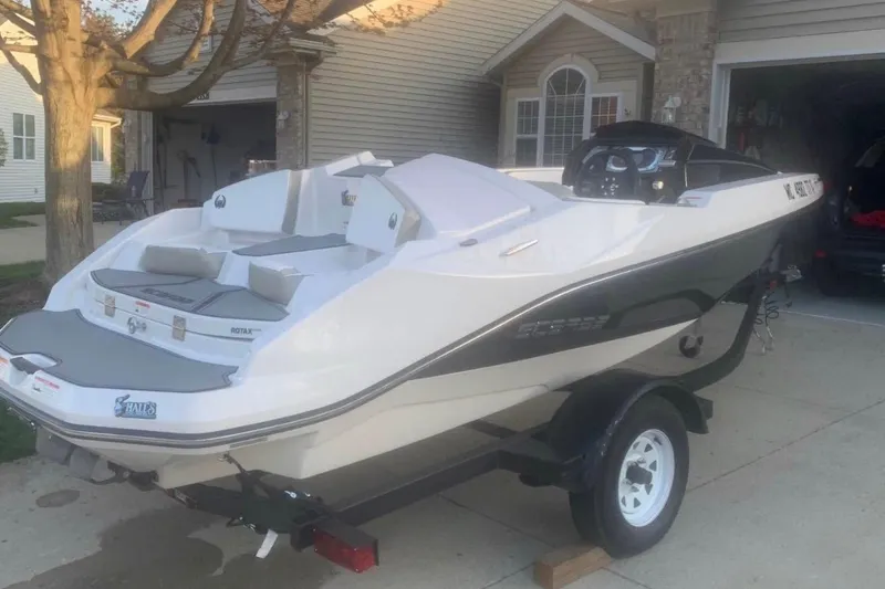 Slide: The Image of 2015 Scarab 165 ID boat on trailer, parked in residential driveway. - 10