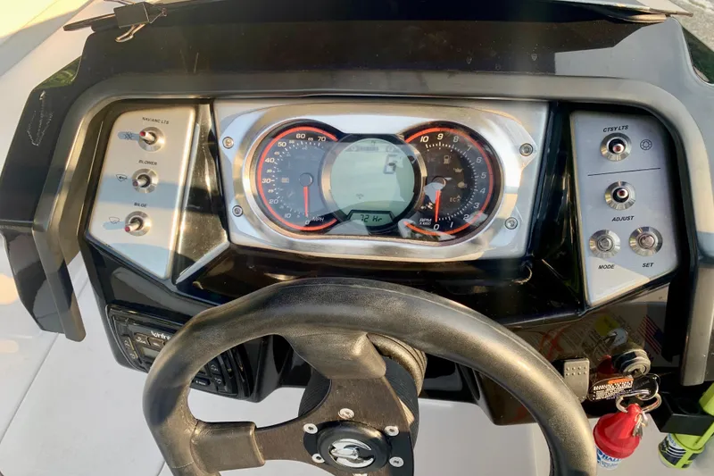 Slide: The Image of Dashboard of a 2015 Scarab 165 ID boat with gauges and controls. - 17