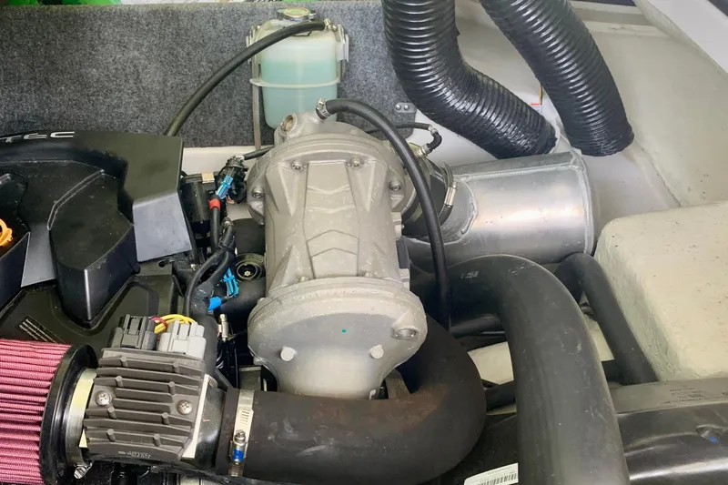 Slide: The Image of Engine compartment of a 2015 Scarab 165 ID boat, showcasing mechanical components. - 19