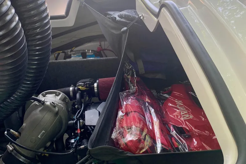 Slide: The Image of Engine compartment of a 2015 Scarab 165 ID boat with visible components and storage. - 20