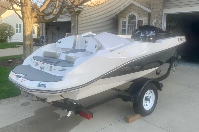 Slide: The Image of 2015 Scarab 165 ID boat on trailer in residential driveway. - 9