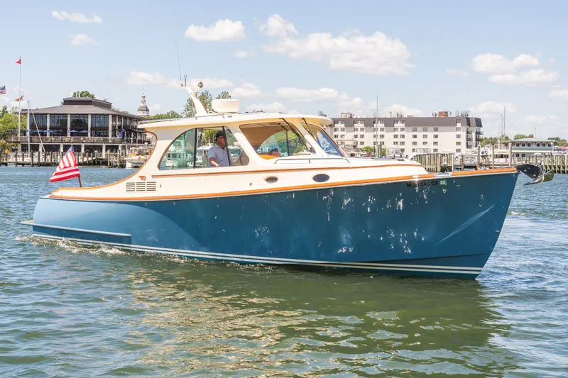 Slide: The Image of 2013 Hinckley Talaria 34 cruising on a sunny day near a marina. - 1