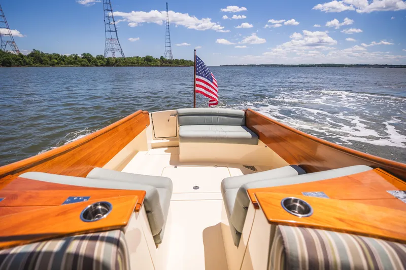 Slide: The Image of Hinckley Talaria 34 boat interior with American flag, cruising on a sunny day. - 10