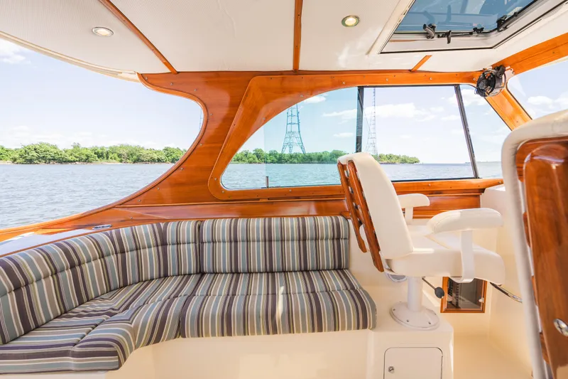 Slide: The Image of Interior of 2013 Hinckley Talaria 34 yacht with striped seating and wooden accents. - 18