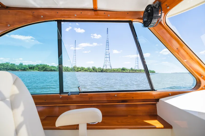 Slide: The Image of Interior view from 2013 Hinckley Talaria 34 boat, overlooking serene water and distant towers. - 27