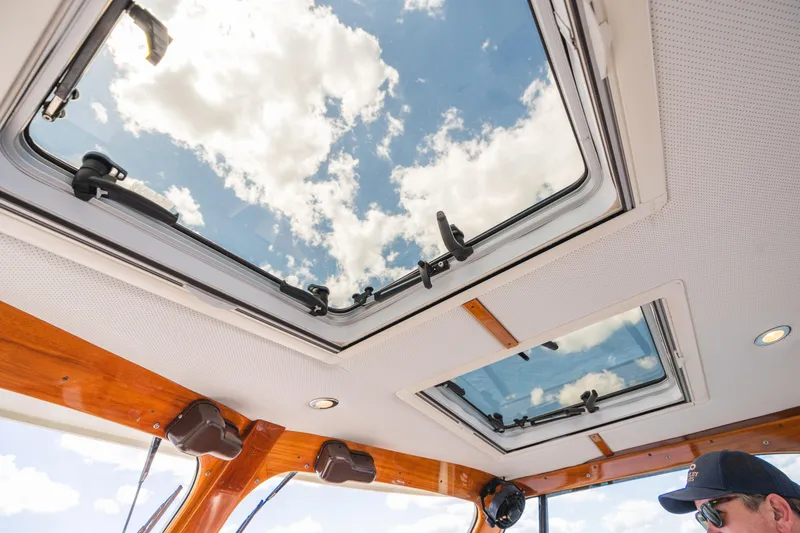 Slide: The Image of Interior view of 2013 Hinckley Talaria 34 yacht with skylights and wooden trim. - 28