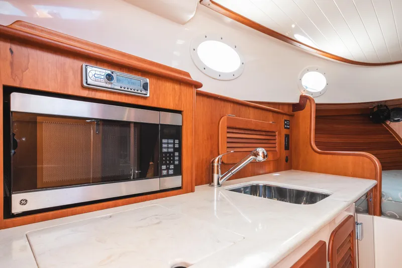 Slide: The Image of Interior of 2013 Hinckley Talaria 34 yacht with modern kitchen amenities. - 31