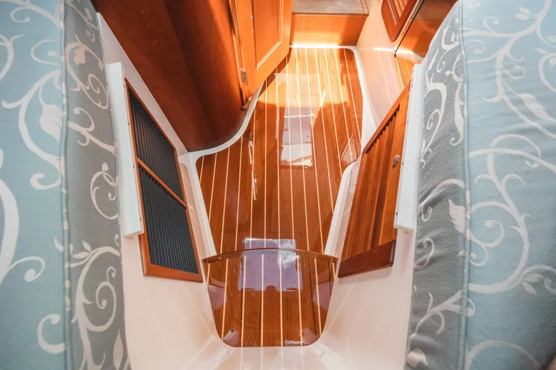 Slide: The Image of Interior of 2013 Hinckley Talaria 34, featuring elegant wood flooring and patterned upholstery. - 34