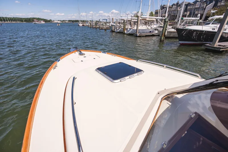 Slide: The Image of 2013 Hinckley Talaria 34 yacht docked at a marina, showcasing elegant design and craftsmanship. - 39