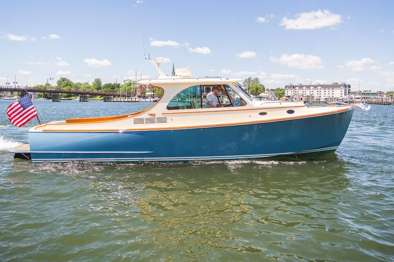 Slide: The Image of 2013 Hinckley Talaria 34 cruising on a sunny day with an American flag. - 43