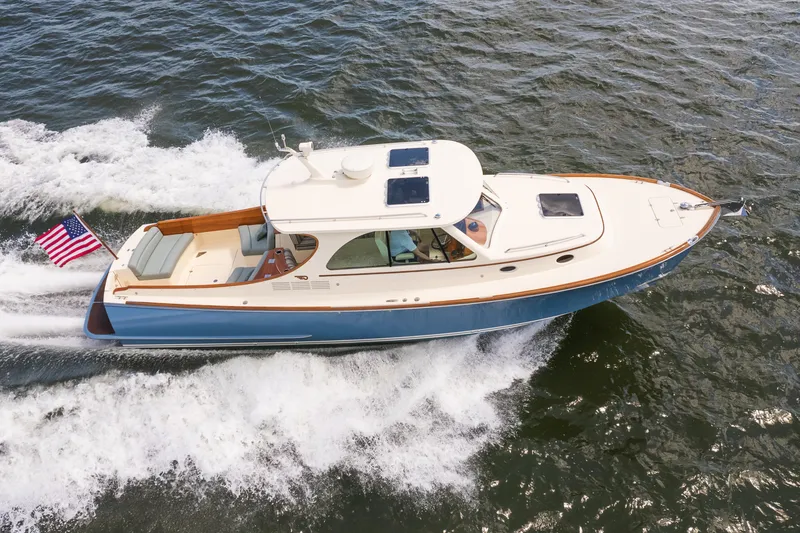Slide: The Image of 2013 Hinckley Talaria 34 cruising on open water with American flag. - 5