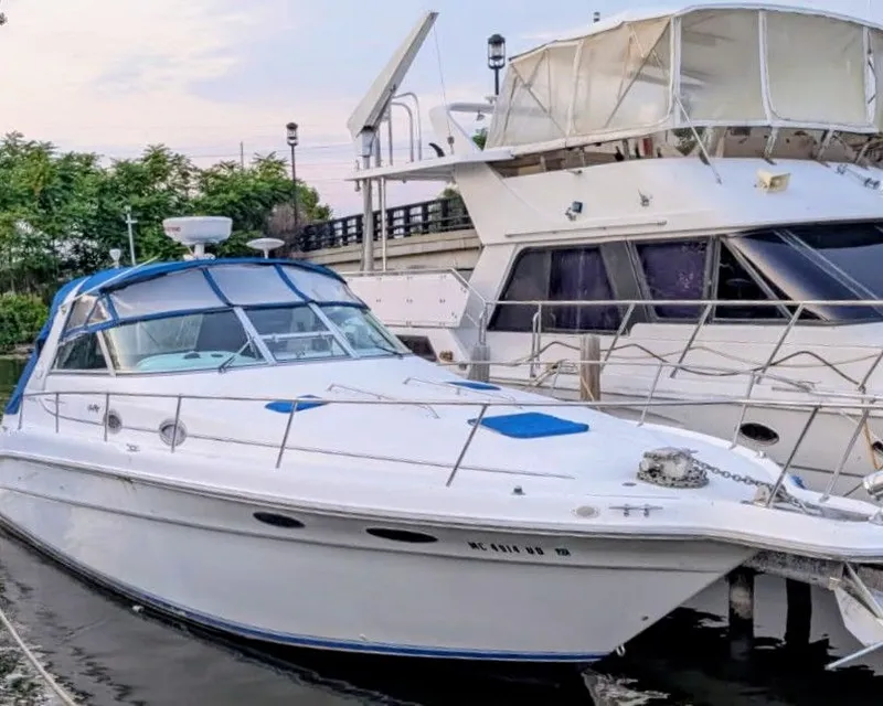 Slide: The Image of 1995 Sea Ray Sundancer 330 yacht docked at marina. - 2