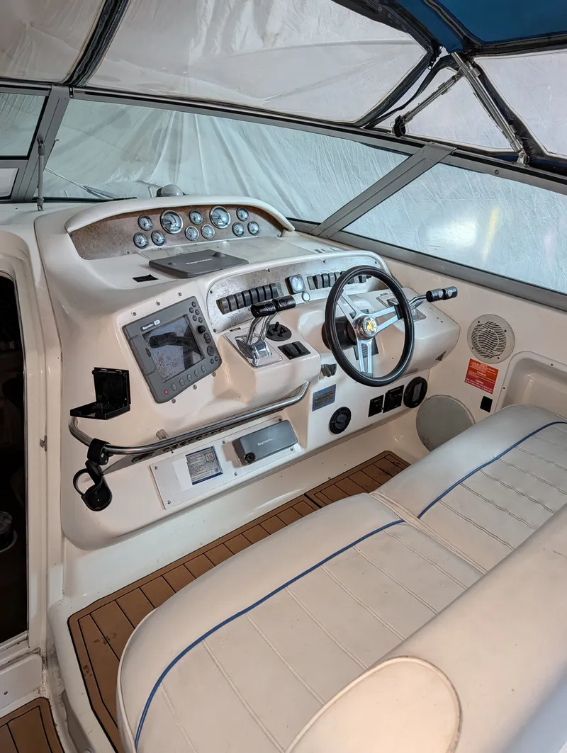 Slide: The Image of 1995 Sea Ray Sundancer 330 interior with helm console. - 3