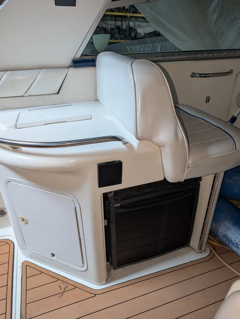 Slide: The Image of Interior of a 1995 Sea Ray Sundancer 330 with white seating and wood deck. - 6