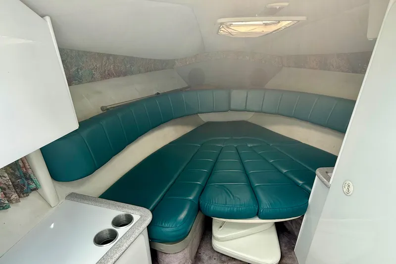 Slide: The Image of Interior of a 1995 Formula 280 Sun Sport boat with teal seating and compact kitchenette. - 16