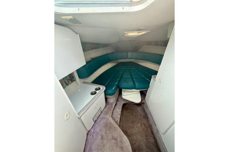 Slide: The Image of Interior of 1995 Formula 280 Sun Sport boat with teal seating and compact cabin layout. - 17