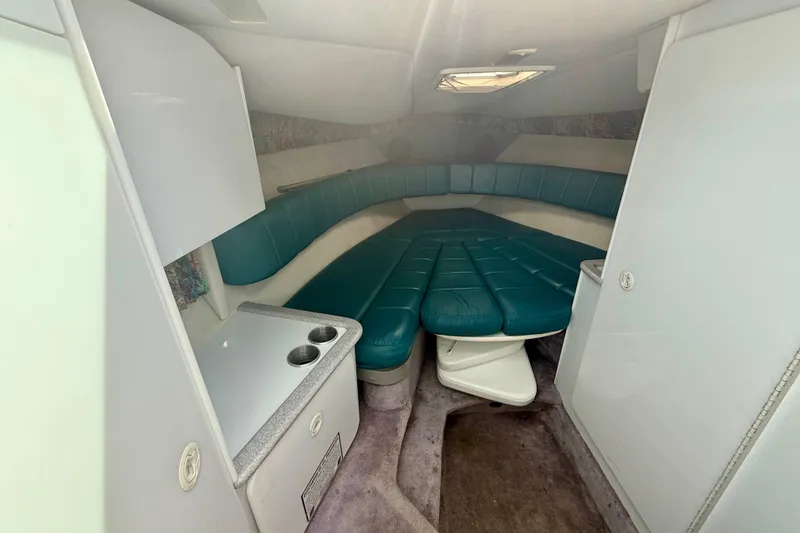 Slide: The Image of Interior of 1995 Formula 280 Sun Sport boat with teal seating and compact amenities. - 18