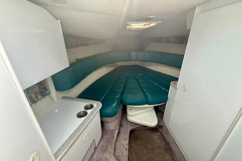 Slide: The Image of Interior of a 1995 Formula 280 Sun Sport boat with teal seating and compact amenities. - 19