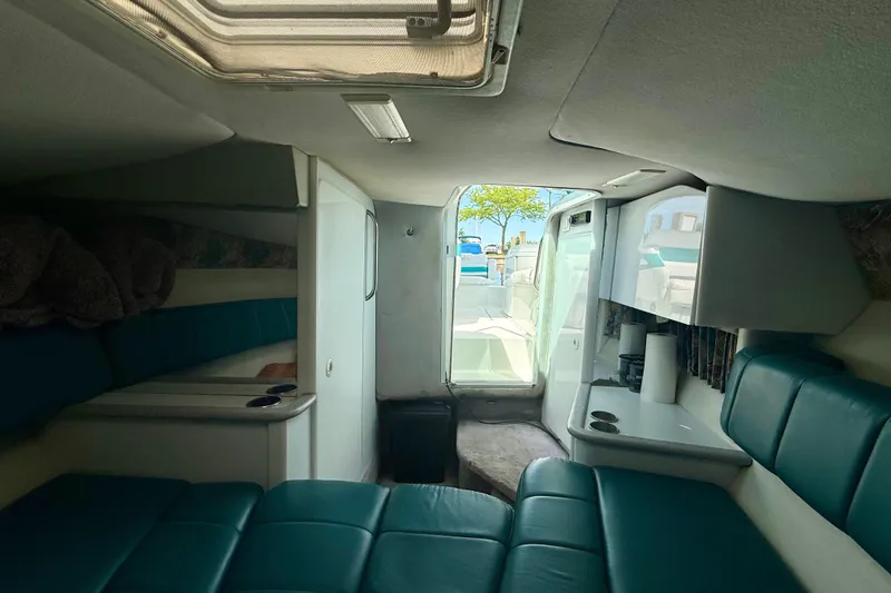 Slide: The Image of Interior of 1995 Formula 280 Sun Sport boat with teal seating and compact cabin layout. - 20