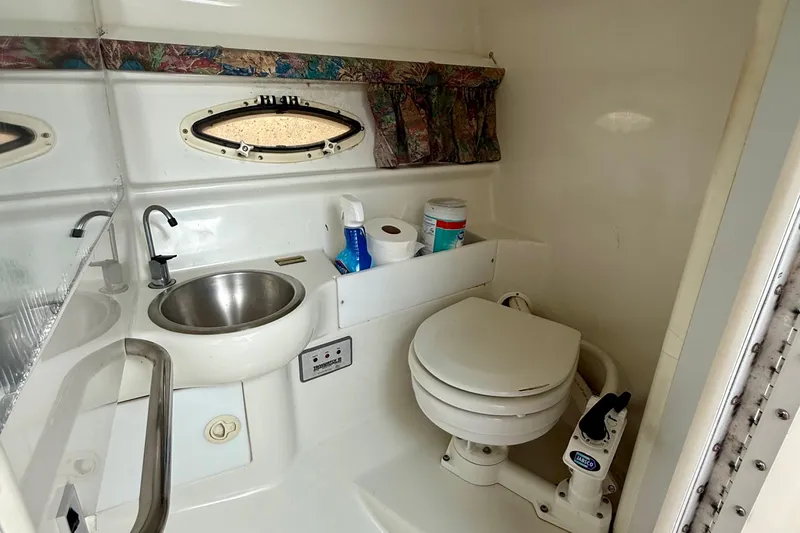 Slide: The Image of 1995 Formula 280 Sun Sport boat bathroom with sink, toilet, and storage. - 22