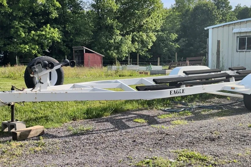 Slide: The Image of White boat trailer for 1995 Formula 280 Sun Sport, parked outdoors near a shed. - 24