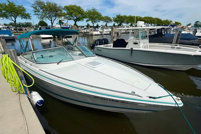 Slide: The Image of 1995 Formula 280 Sun Sport boat docked at marina with blue canopy. - 3
