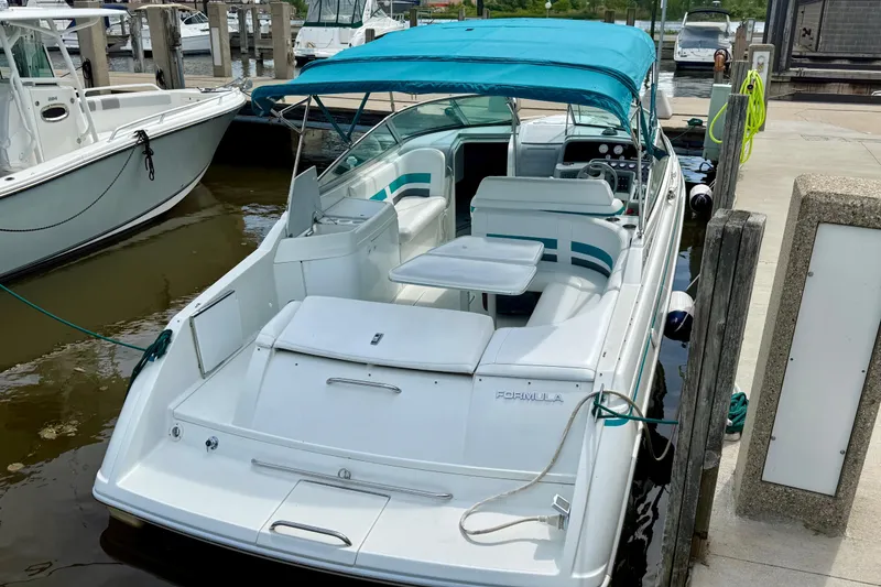 Slide: The Image of 1995 Formula 280 Sun Sport boat docked with blue canopy and white seating. - 5