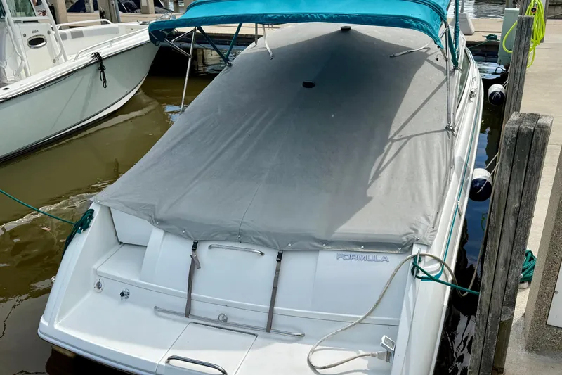 Slide: The Image of 1995 Formula 280 Sun Sport boat docked with cover and blue canopy. - 8